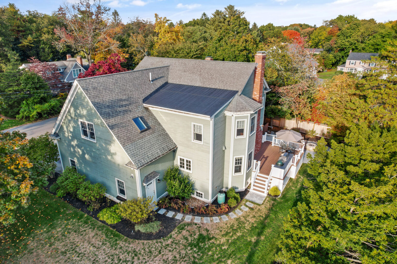 Aerial shot of hillside house surrounded by trees, SFV listing.