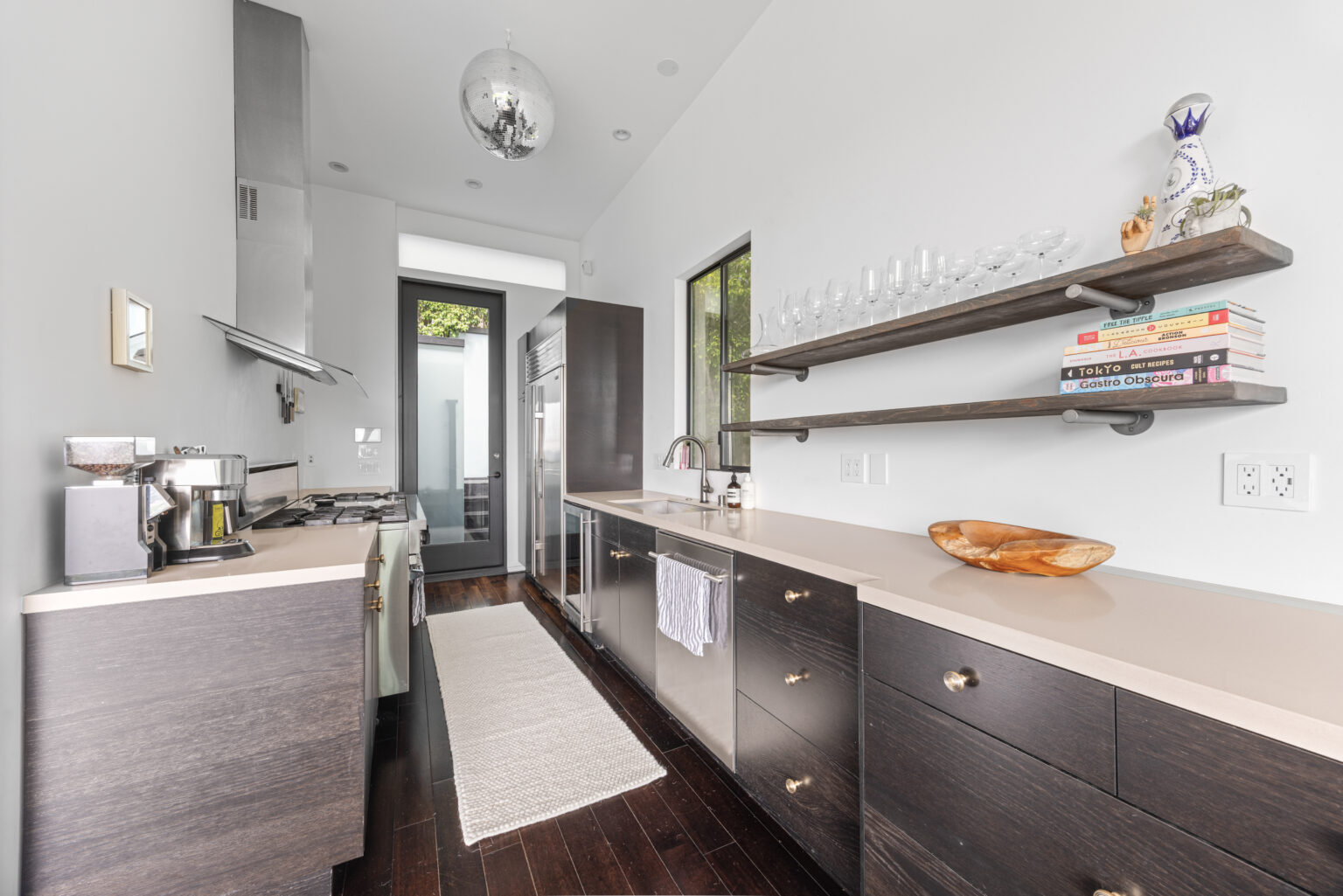 Narrow galley kitchen with door to patio, Southern California property.