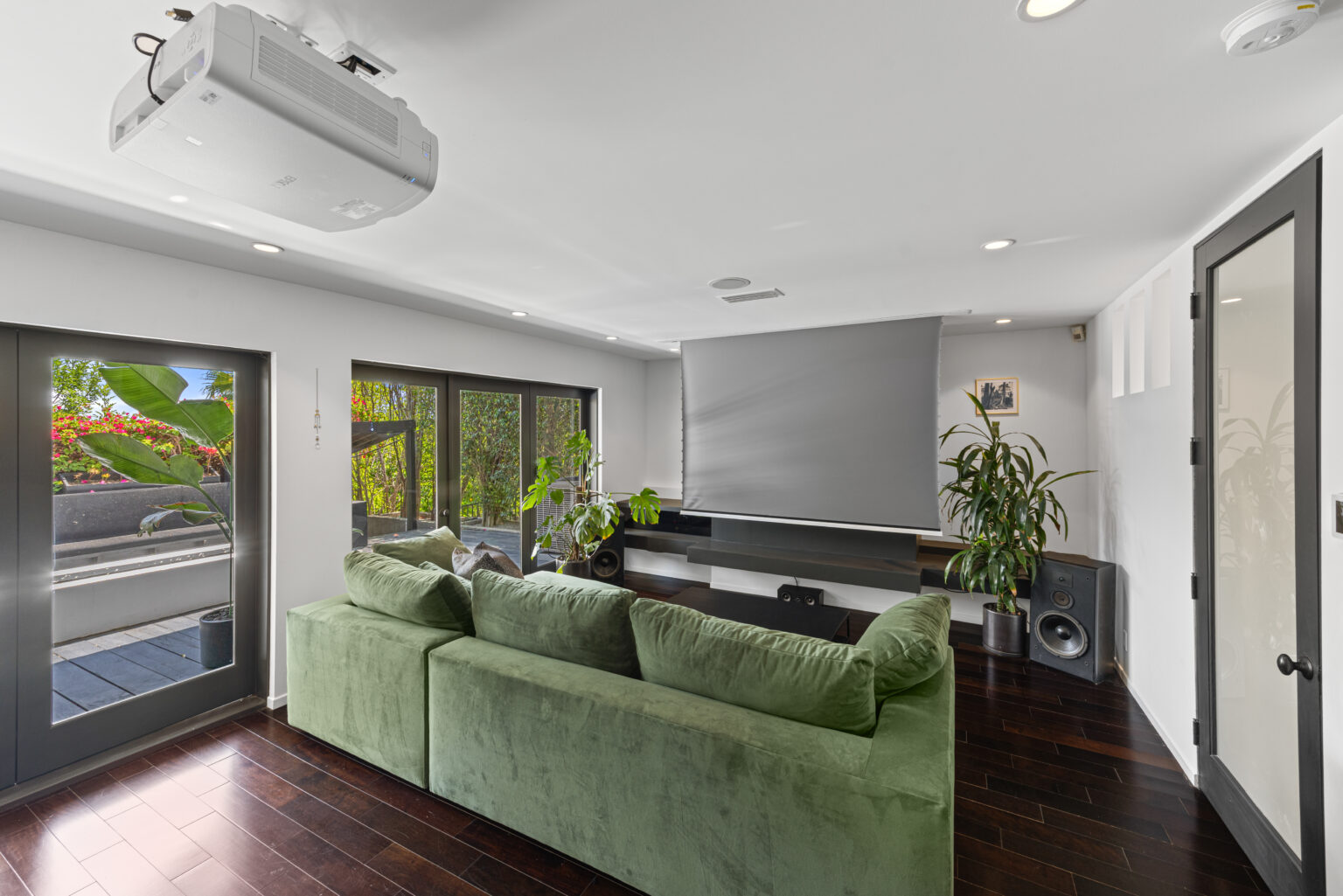Home theater or media room with green sofa and projection screen