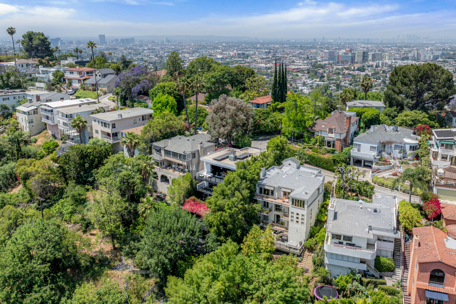Aerial of residential homes and trees in Los Angeles, Southern California listing.