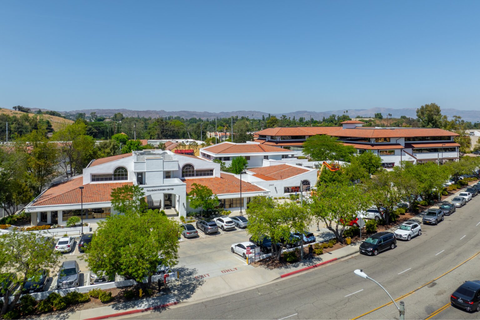 Drone view of retail center and green hills