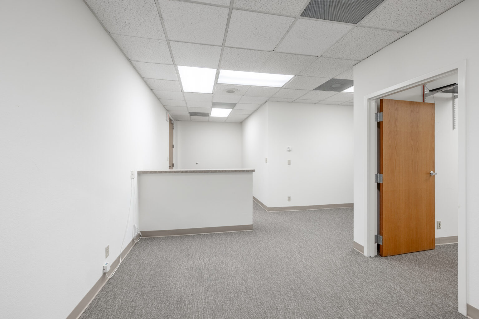 Same office from different angle, window and door visible