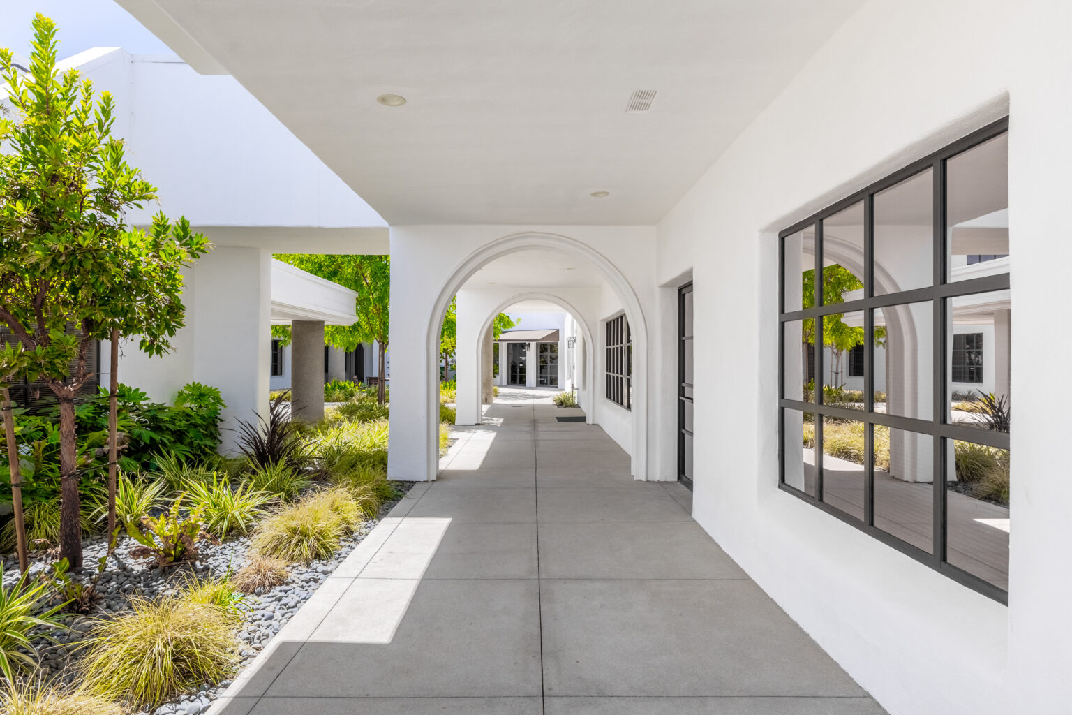 Covered walkway with columns and storefronts