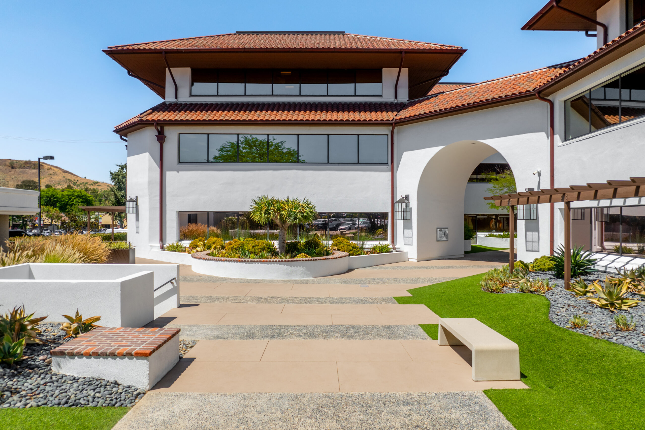 Exterior view of white commercial building with arches