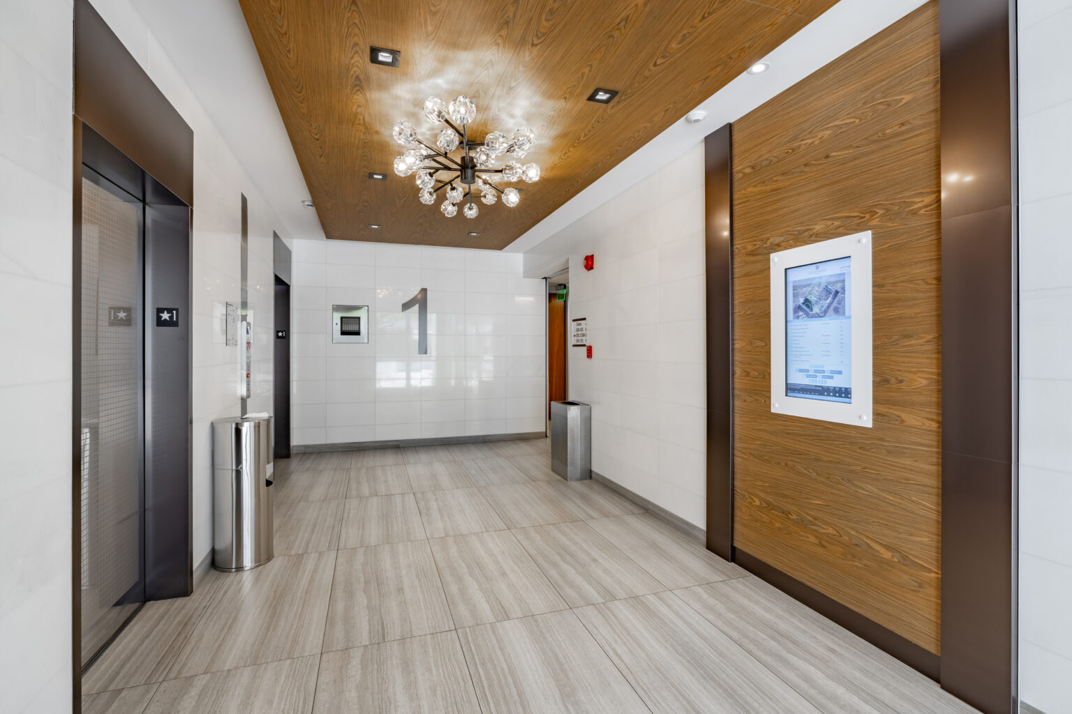 Lobby interior with modern chandelier and elevators