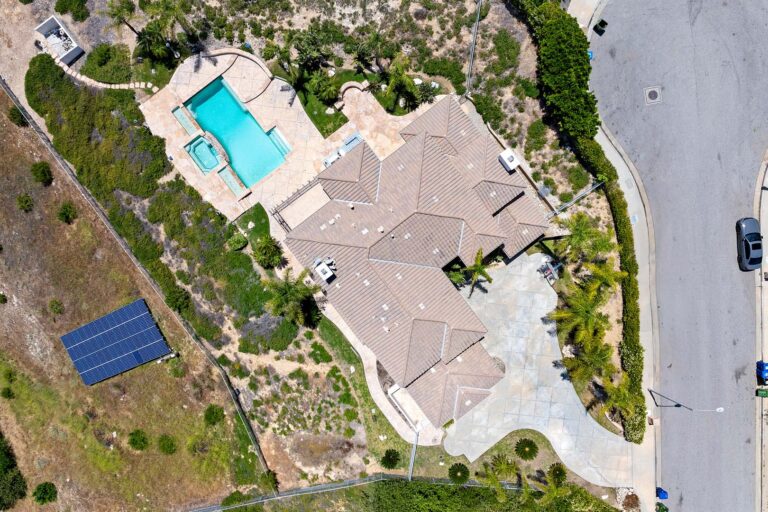 Drone top-down of pool area and surrounding patio