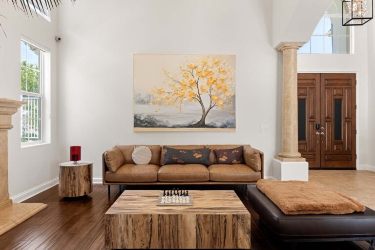 Living area with tall ceiling, large plant, and seating