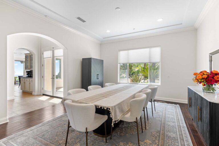 Same dining space with wide window and rug