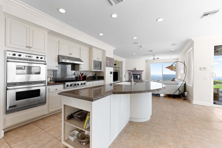 Modern kitchen with island, double oven, and pantry