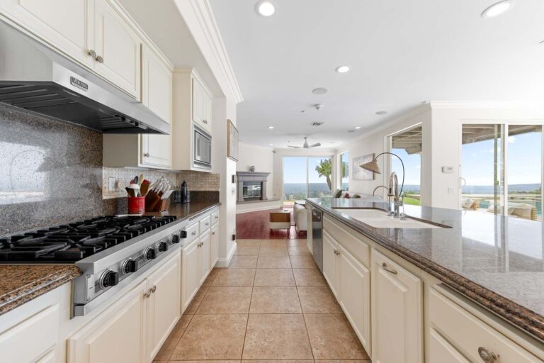Bright kitchen with stove, island, and open counter