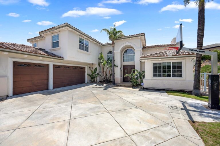 Front exterior of house with driveway and garage