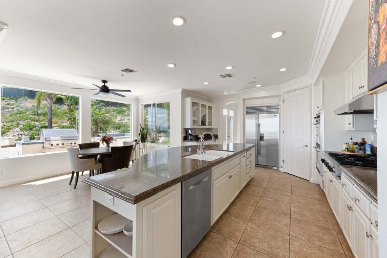 Kitchen island and dining nook with window view