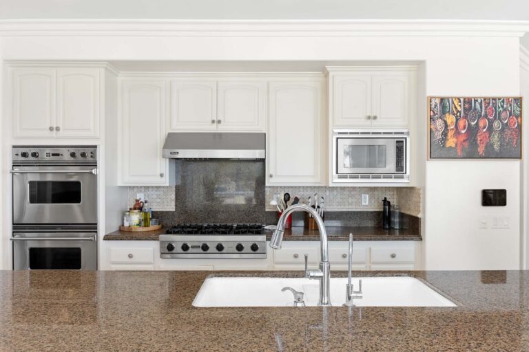Close-up of kitchen with range, oven, and hood