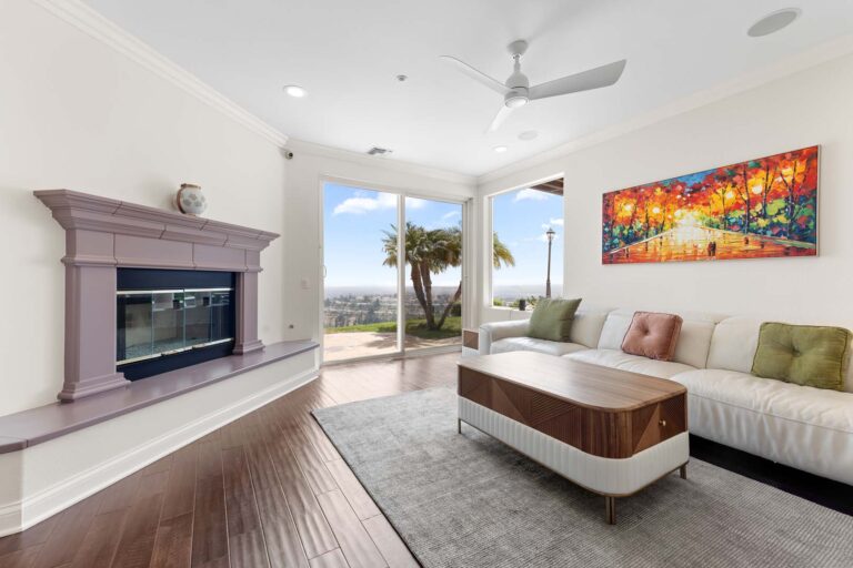 Living area with fireplace, armchair, and patio view