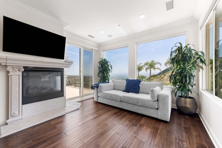 Bright living room with fireplace and blue armchair