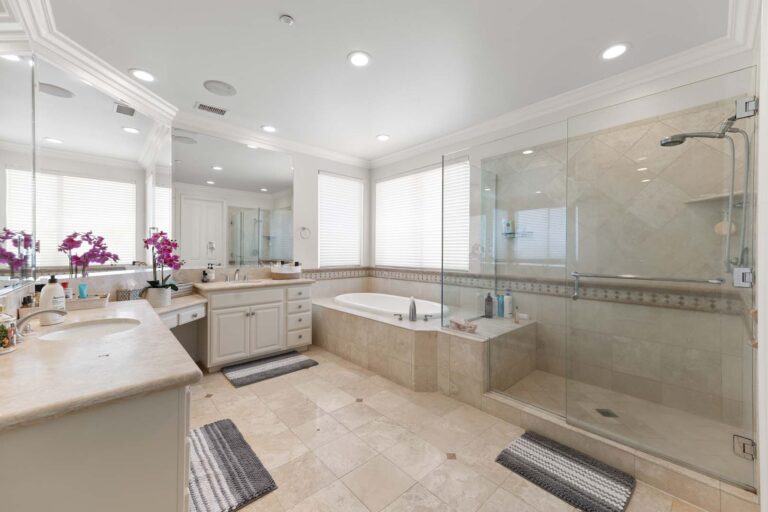 Large bathroom with double vanity and bathtub