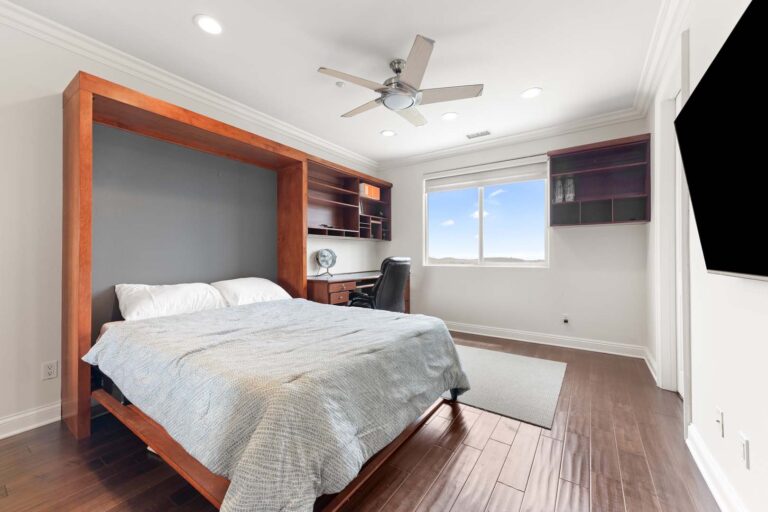 Guest bedroom with bed and built-in shelves